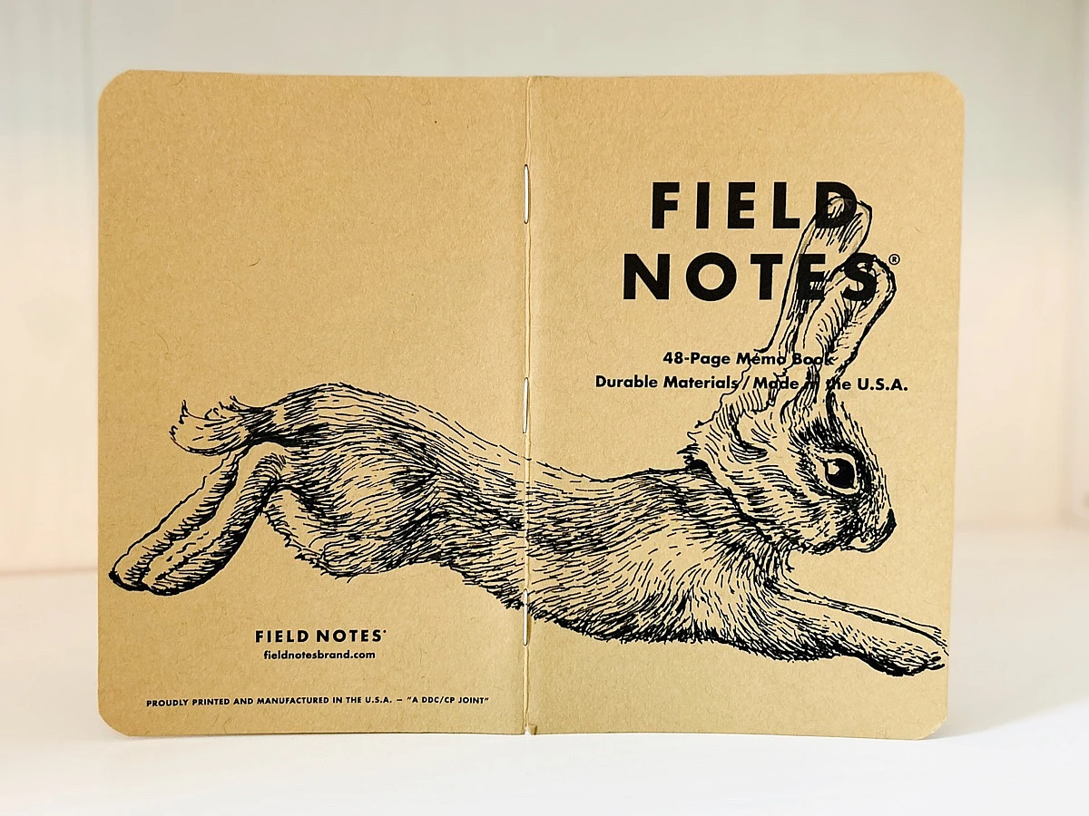 Aufgeklapptes Field Notes Heft. Auf dem Rücken die Illustration eines von links nach rechts springenden Hasen.