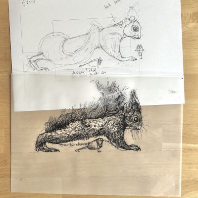 Die Bleistift-Zeichnung eines Eichhörnchens auf einem weißen Blatt und darüber die Tinte-Zeichnung auf Transparentpapier. Beides liegt auf einem Holztisch.
