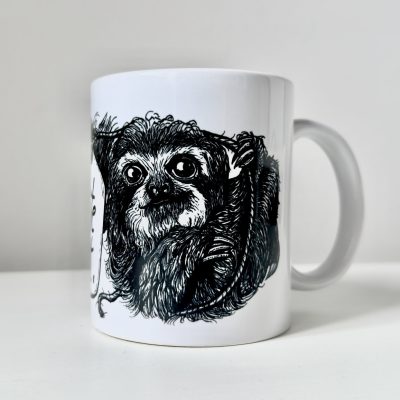 Eine Keramiktasse mit Henkel nach links. Zu sehen ist die schwarze Zeichnung eines Faultiers.